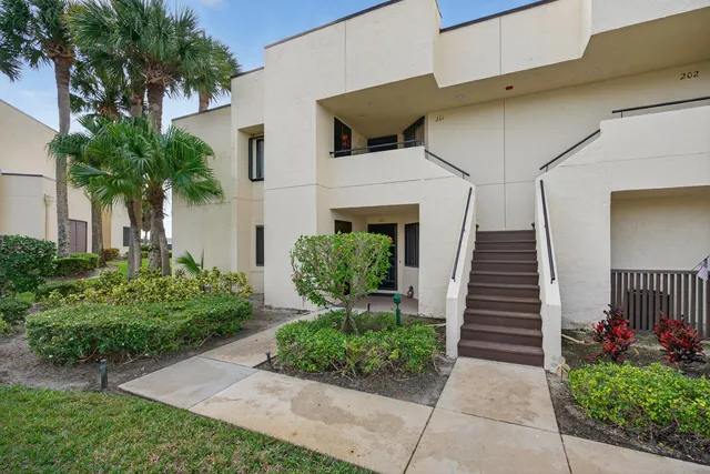 a view of a hallway with wooden floor and stairs