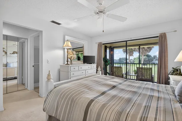 a bedroom with a large bed and a large window