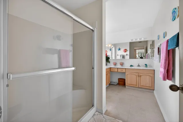 a bathroom with a sink vanity toilet and shower