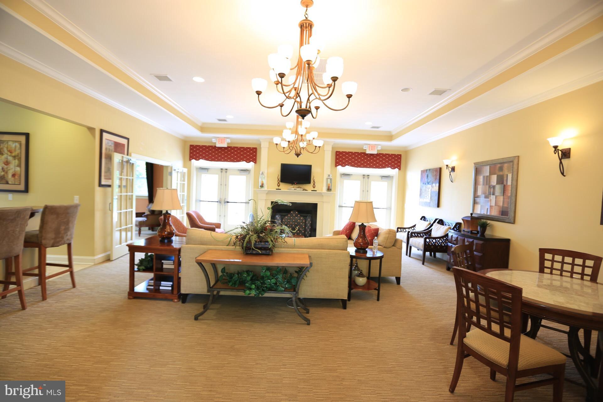 413 Timberlake Drive Ewing, NJ 08618 - Photo 11 of 26 a living room with fireplace furniture and a chandelier