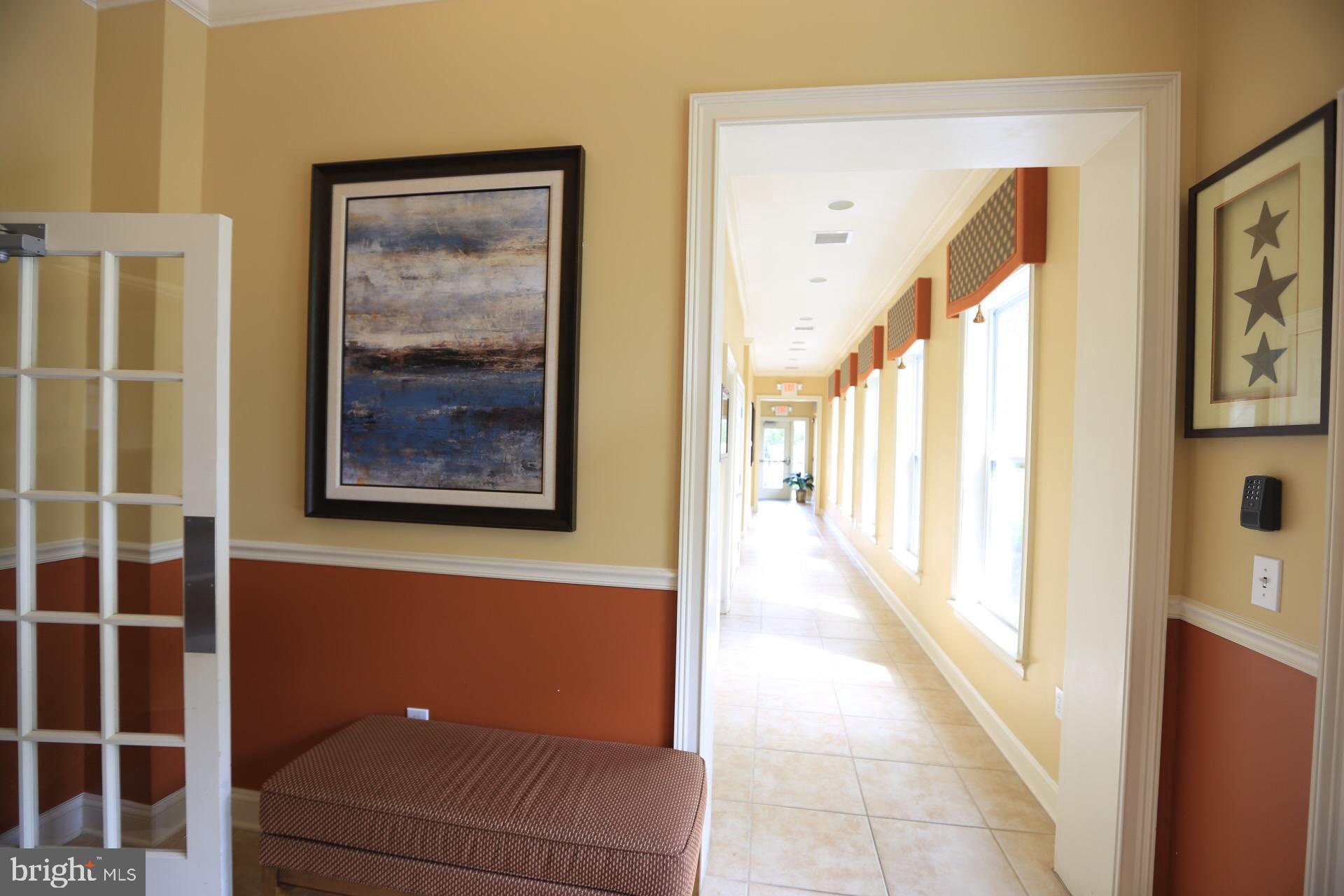 413 Timberlake Drive Ewing, NJ 08618 - Photo 18 of 26 a view of a hallway with paintings on the wall
