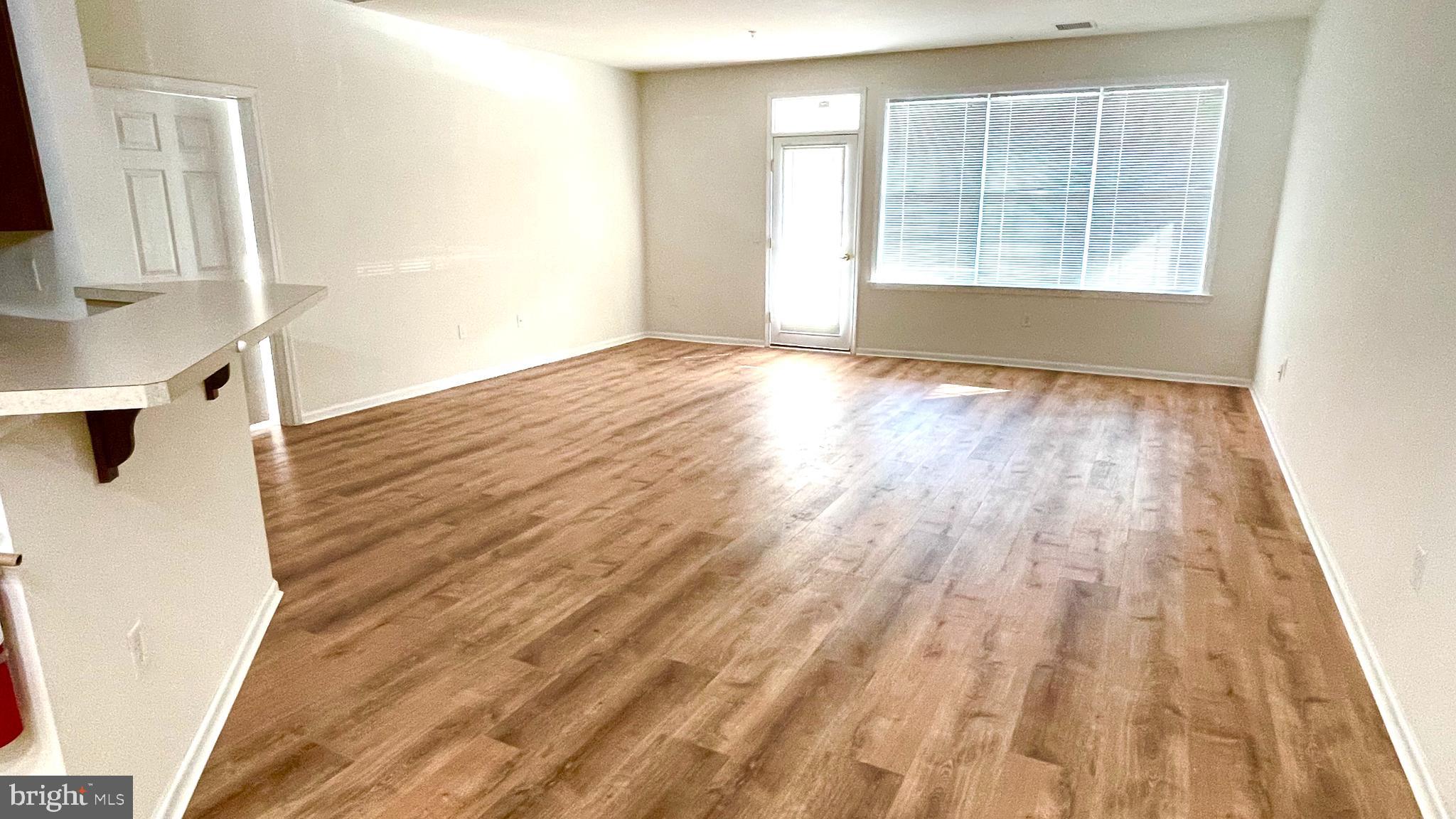 413 Timberlake Drive Ewing, NJ 08618 - Photo 2 of 26 an empty room with wooden floor and windows