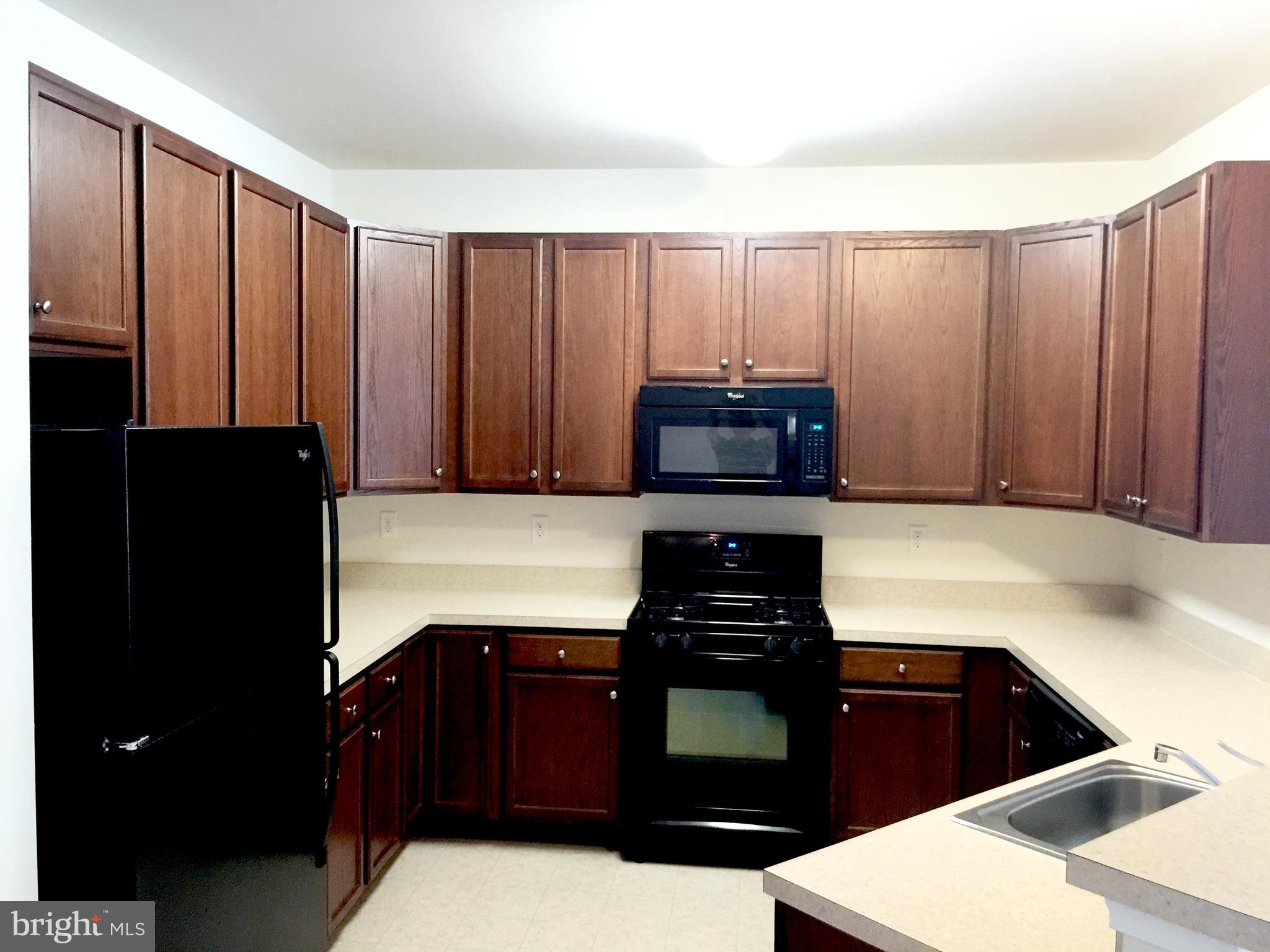 413 Timberlake Drive Ewing, NJ 08618 - Photo 3 of 26 a kitchen with a refrigerator and cabinets