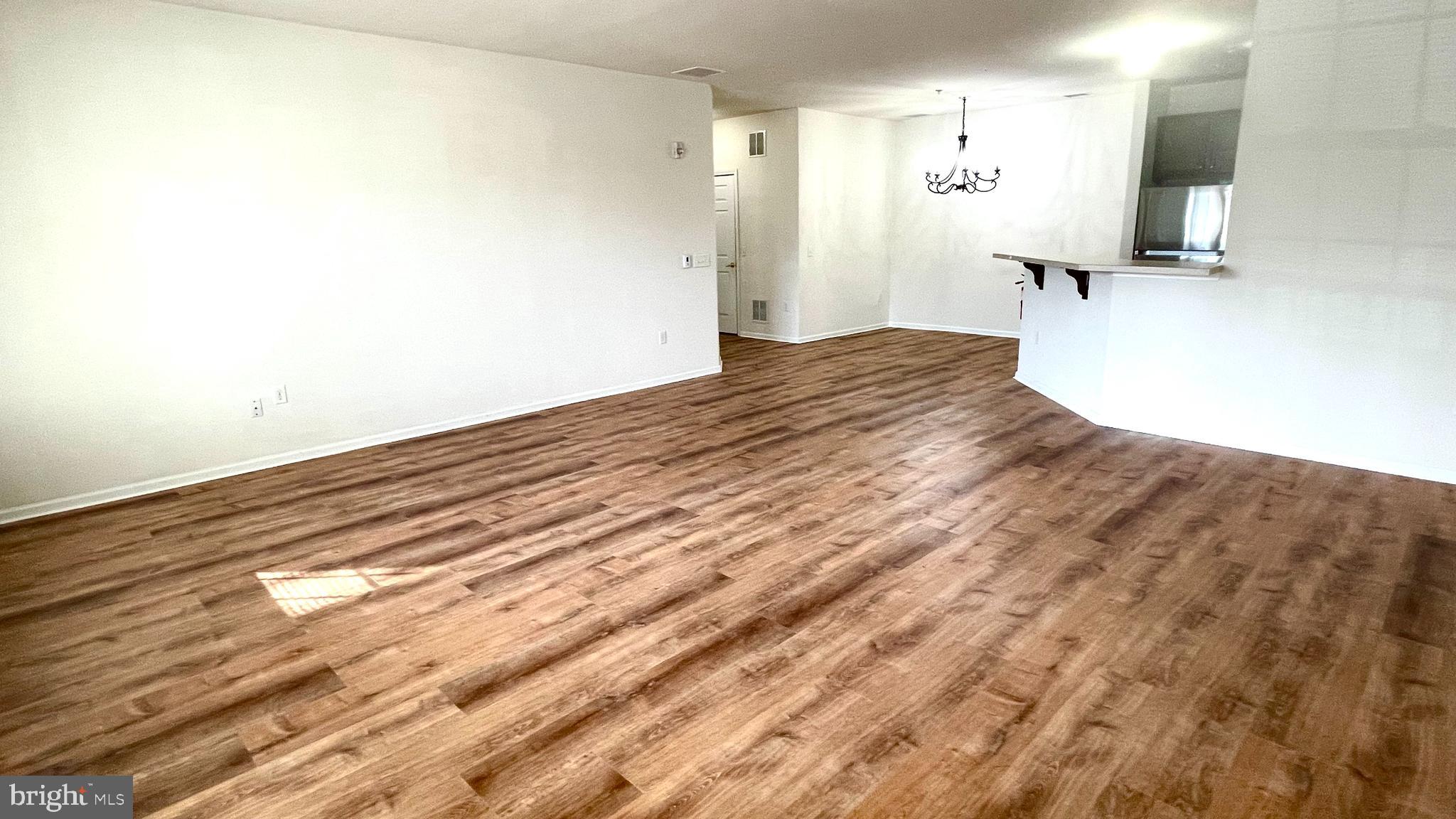 413 Timberlake Drive Ewing, NJ 08618 - Photo 4 of 26 a view of a bedroom with wooden floor and a flat screen tv