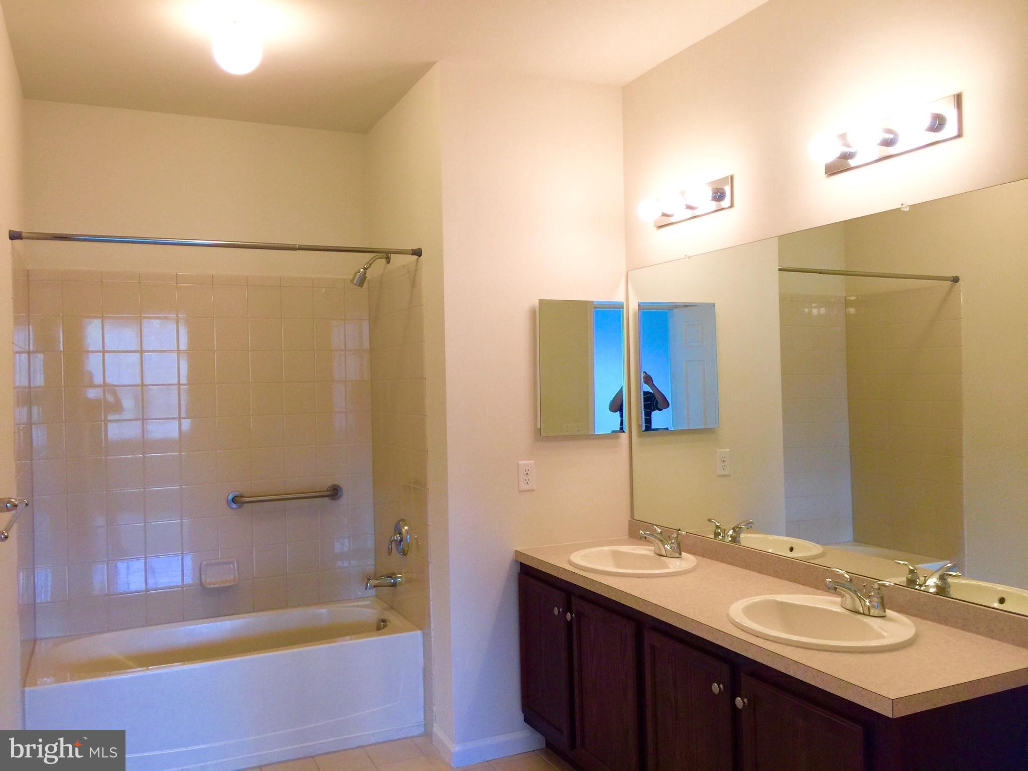 413 Timberlake Drive Ewing, NJ 08618 - Photo 9 of 26 a bathroom with a sink and a mirror