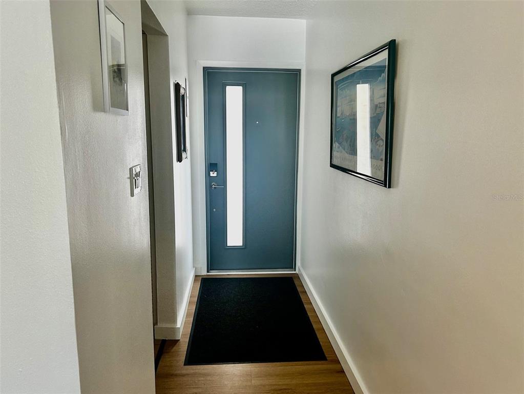 500 South Washington Drive, Unit 24B Sarasota, FL 34236 - Photo 11 of 25 a view of a hallway with wooden floor and entryway