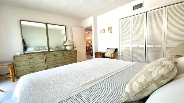 a bedroom with a bed and a mirror