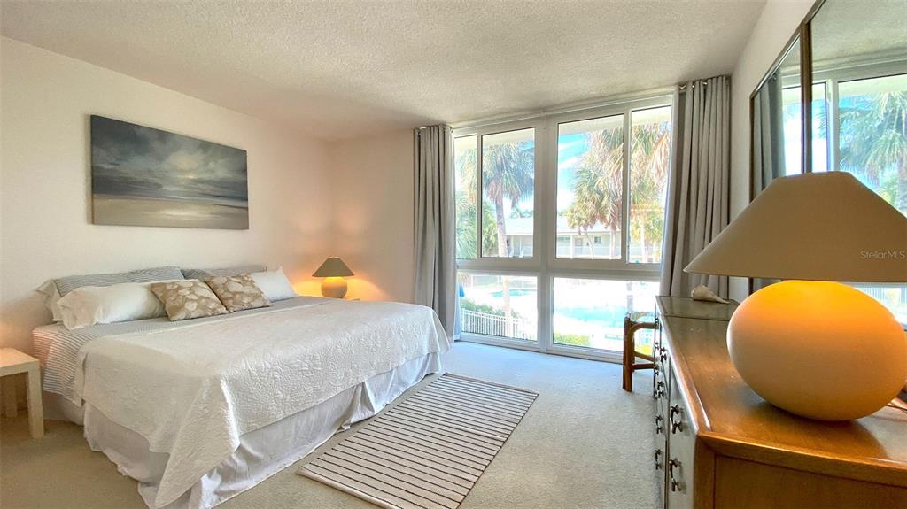 500 South Washington Drive, Unit 24B Sarasota, FL 34236 - Photo 21 of 25 a bedroom with a bed and a large window