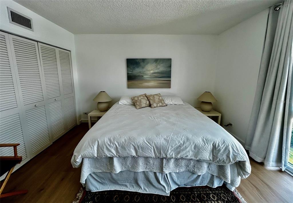 500 South Washington Drive, Unit 24B Sarasota, FL 34236 - Photo 22 of 25 a bedroom with a bed and wooden floor
