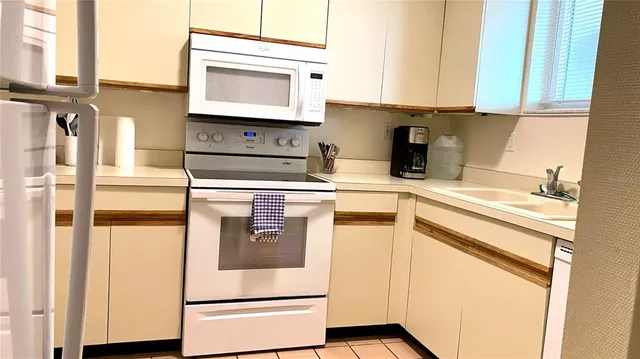 a kitchen with stainless steel appliances granite countertop a sink and a microwave