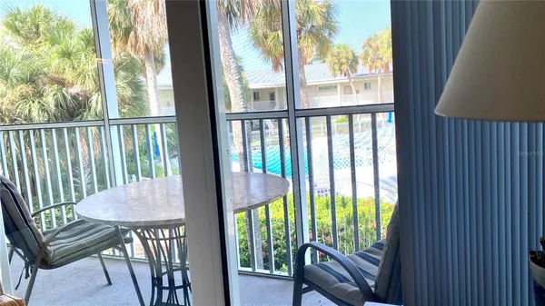 a view from a dining room with furniture window and outside view