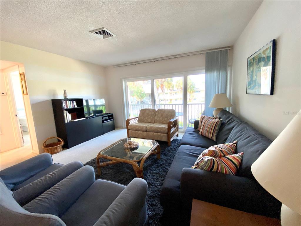 500 South Washington Drive, Unit 24B Sarasota, FL 34236 - Photo 10 of 25 a living room with furniture and a flat screen tv