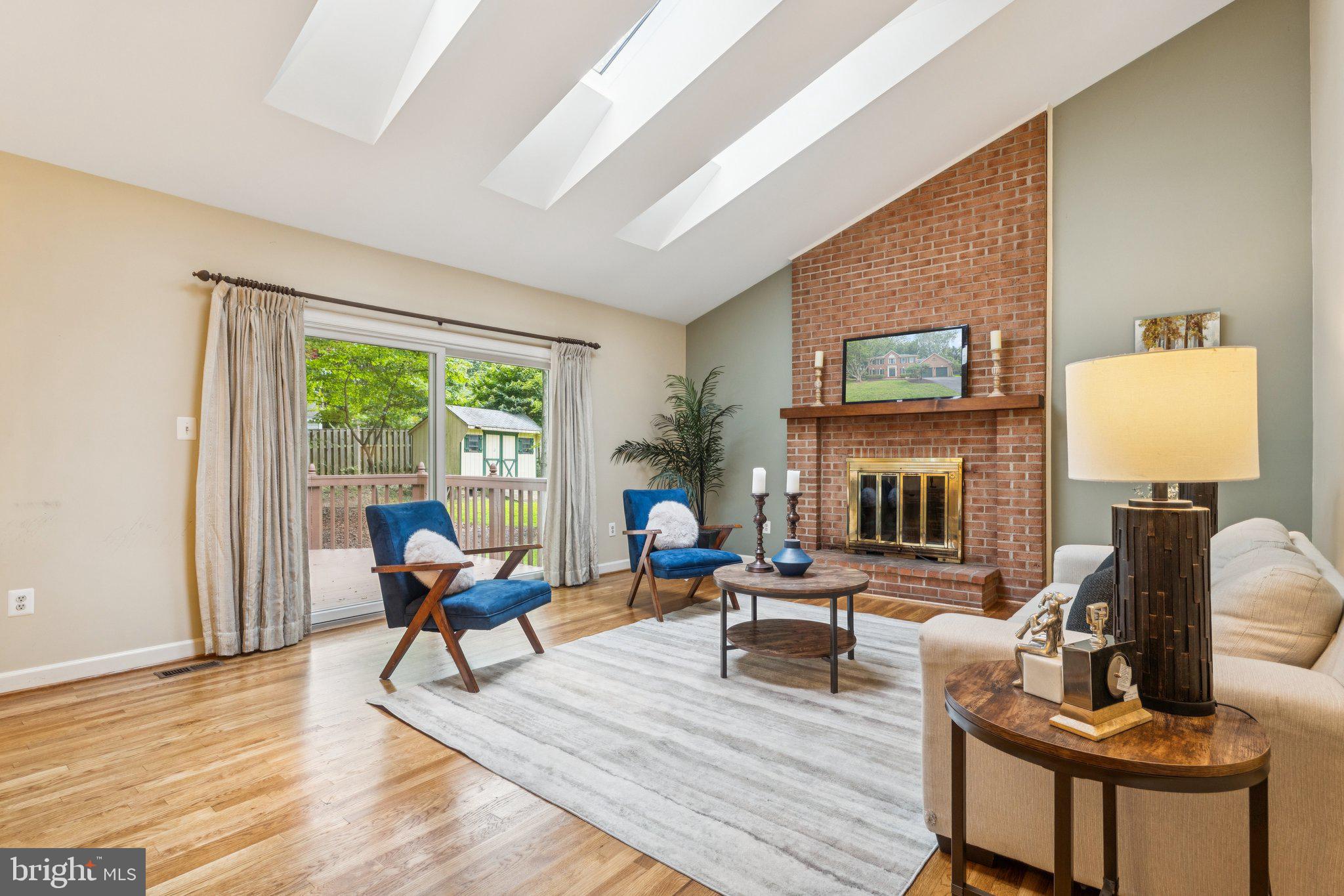 15313 Watergate Road Silver Spring, MD 20905 - Photo 17 of 53 a living room with furniture a fireplace and a table