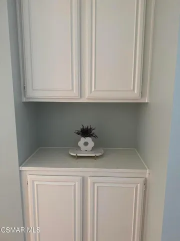 a kitchen with a white cabinets and a stove top oven
