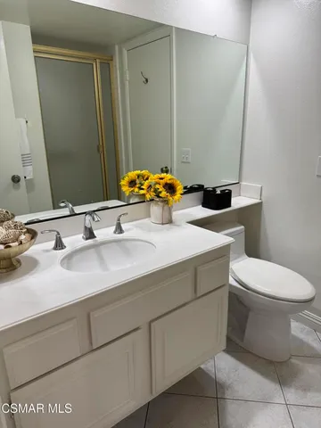 a bathroom with a sink toilet and mirror