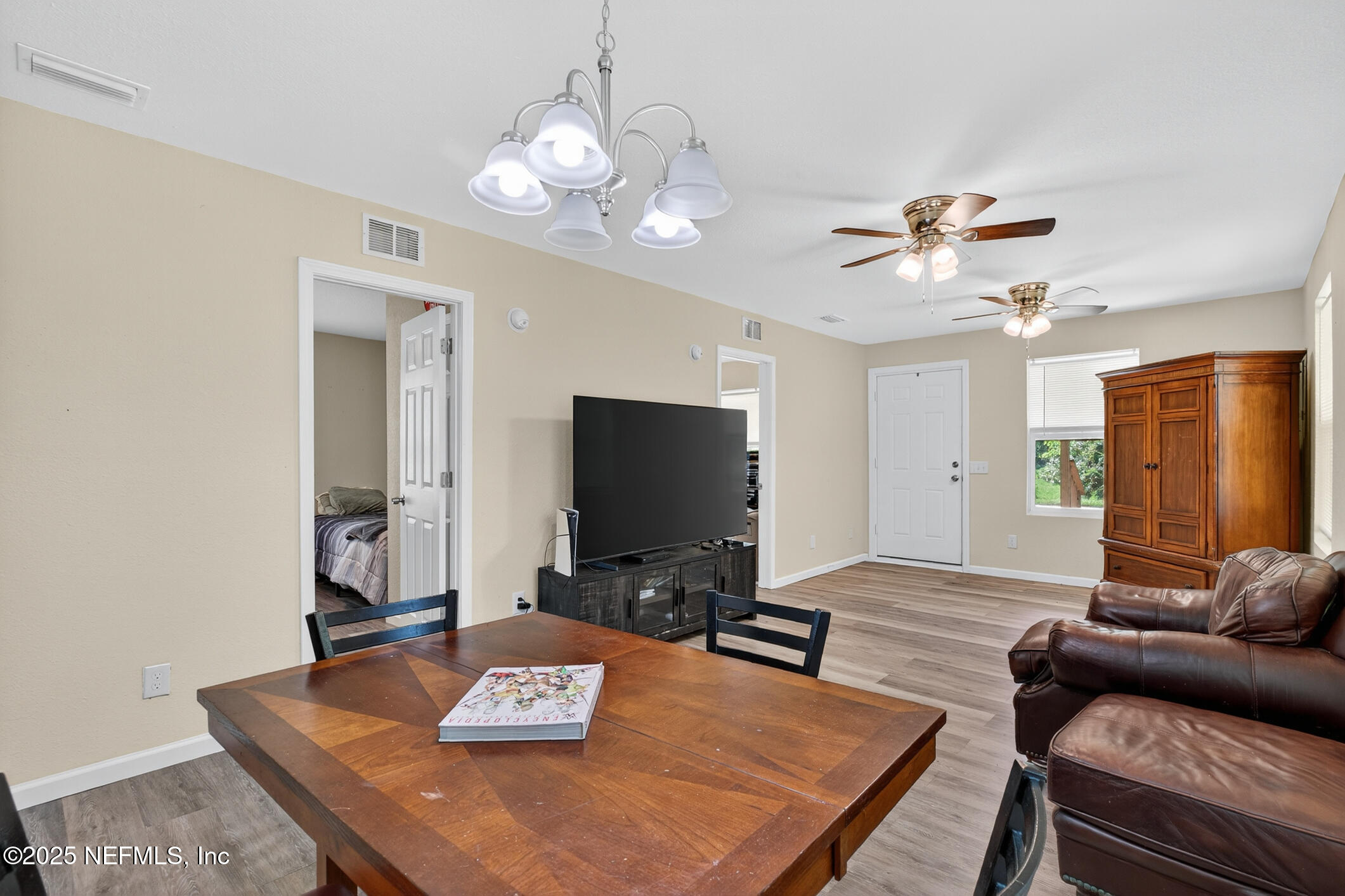 631 Moore Street Baldwin, FL 32234 - Photo 12 of 36 a living room with furniture and a flat screen tv