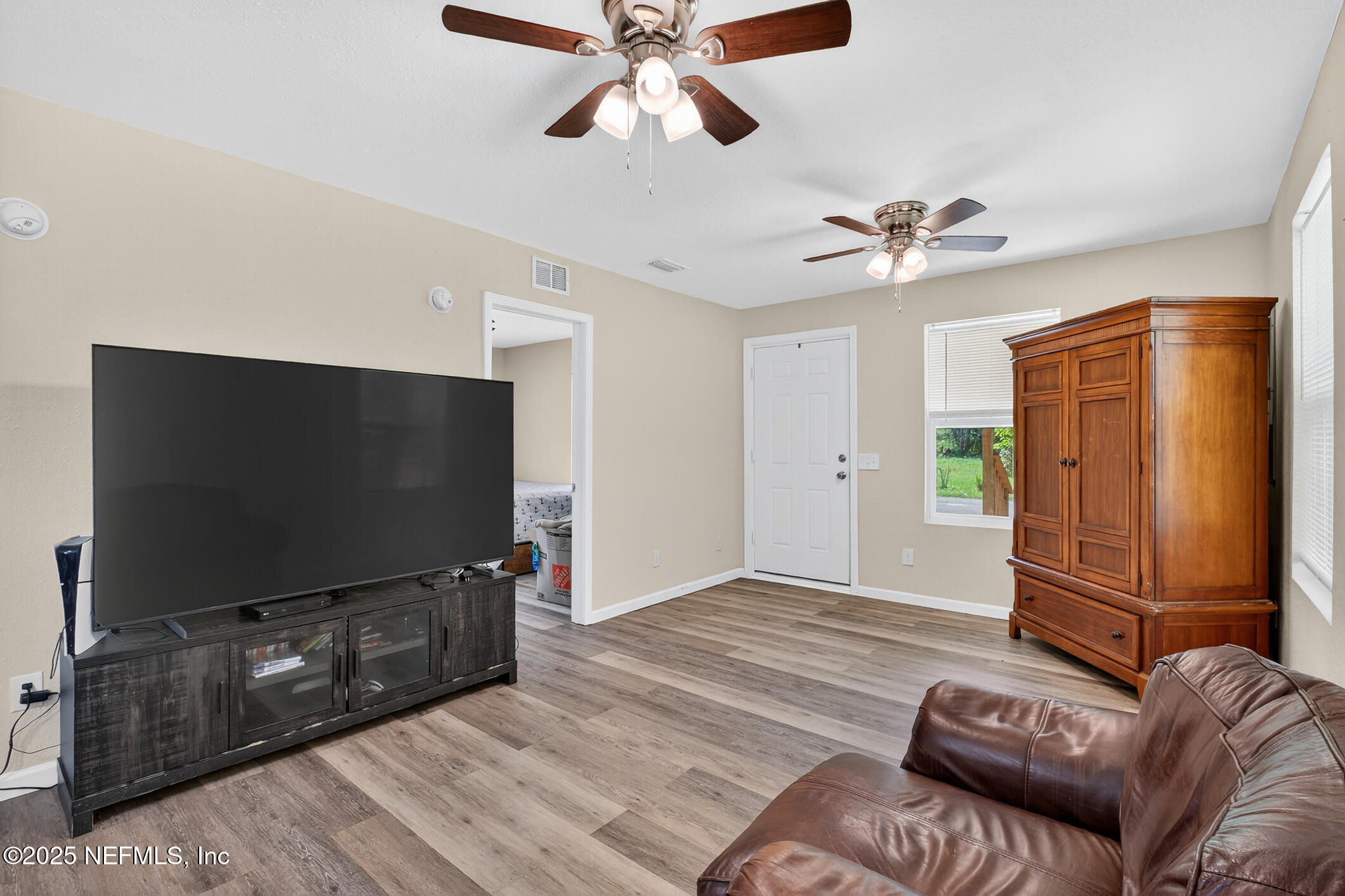 631 Moore Street Baldwin, FL 32234 - Photo 13 of 36 a living room with furniture and a flat screen tv