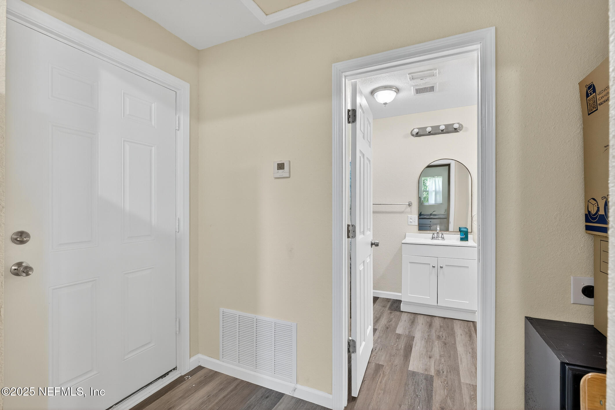 631 Moore Street Baldwin, FL 32234 - Photo 18 of 36 a view of a bathroom from the hallway