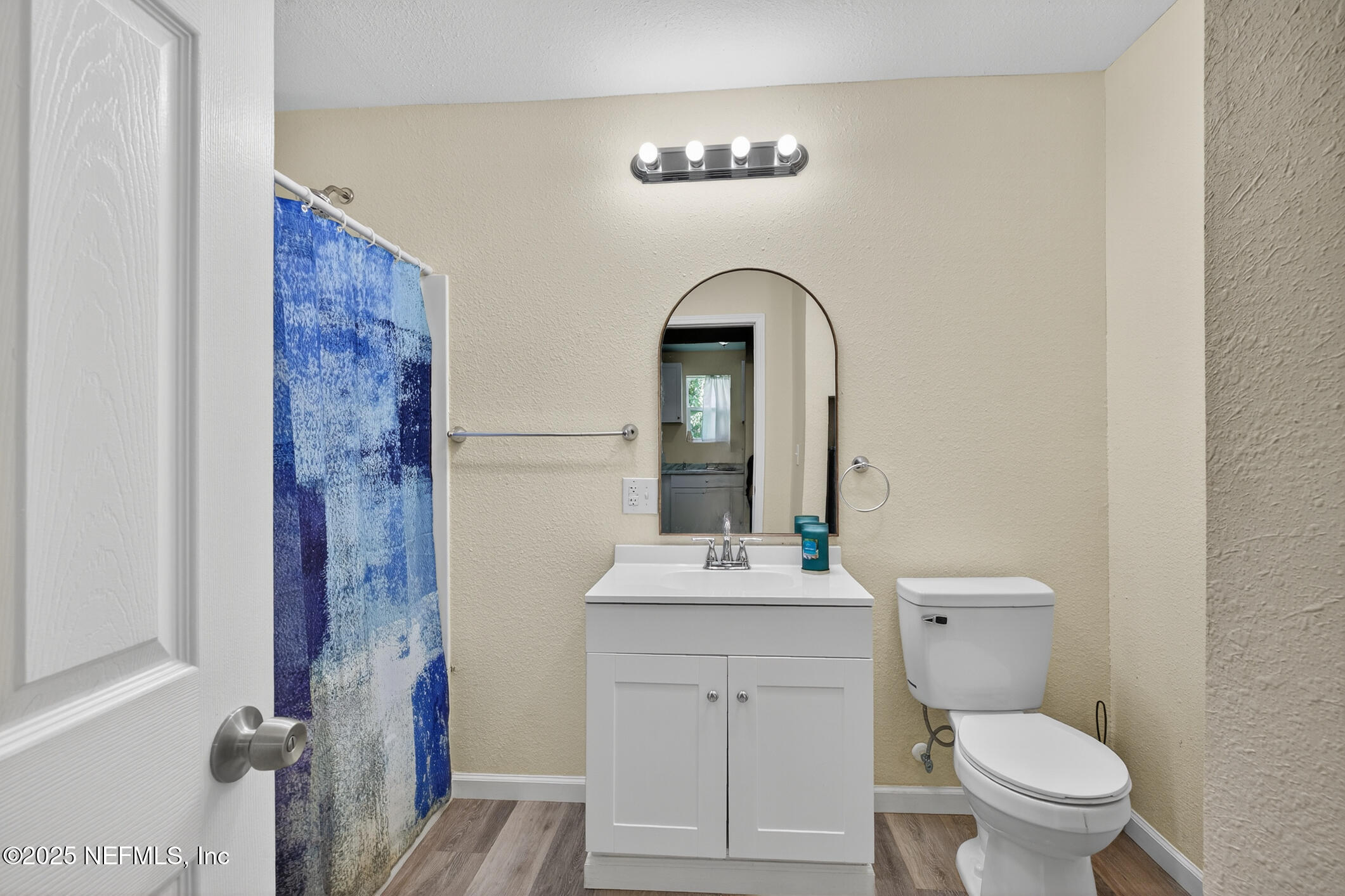 631 Moore Street Baldwin, FL 32234 - Photo 20 of 36 a bathroom with a toilet a sink and mirror