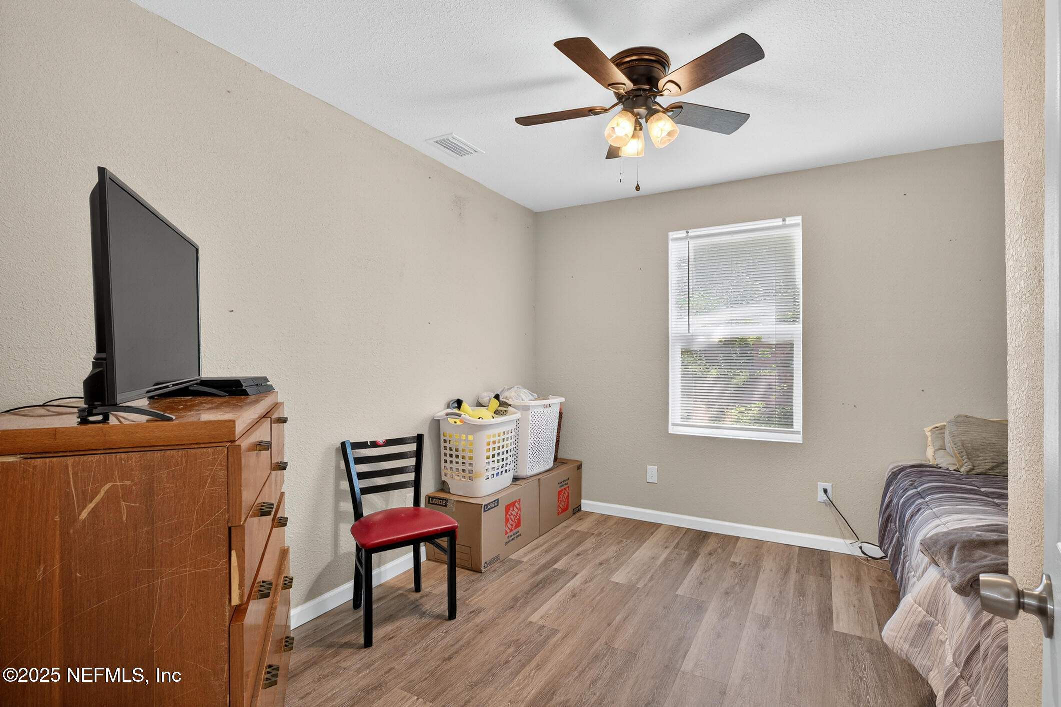 631 Moore Street Baldwin, FL 32234 - Photo 23 of 36 a living room with furniture and a flat screen tv