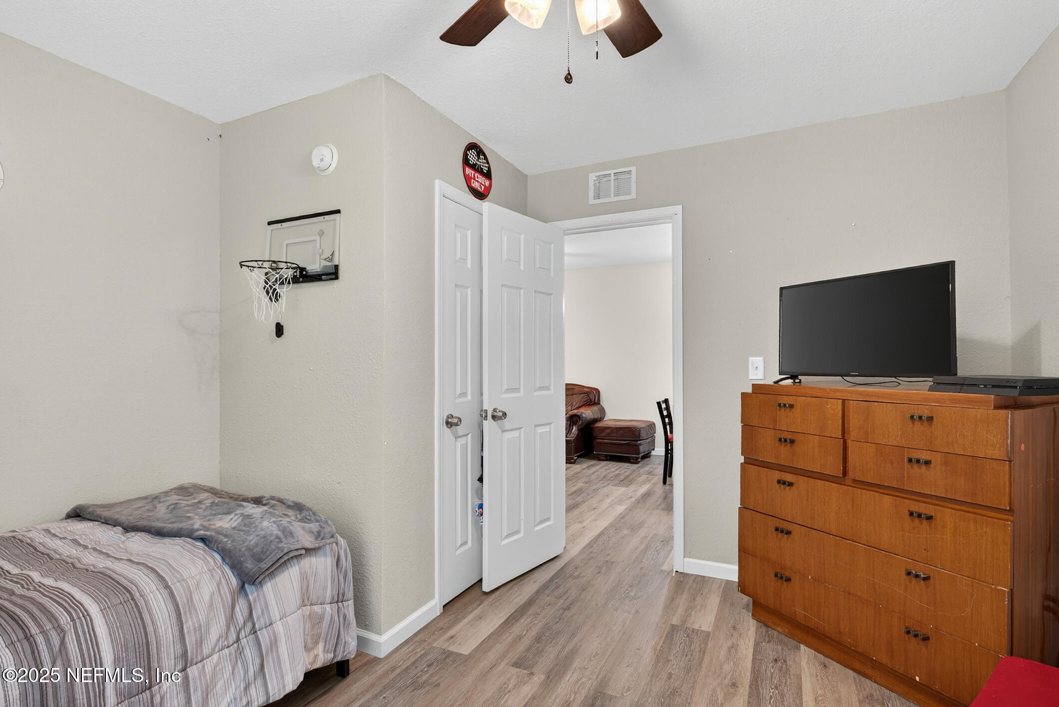 631 Moore Street Baldwin, FL 32234 - Photo 25 of 36 a bedroom with a dresser and a flat screen tv