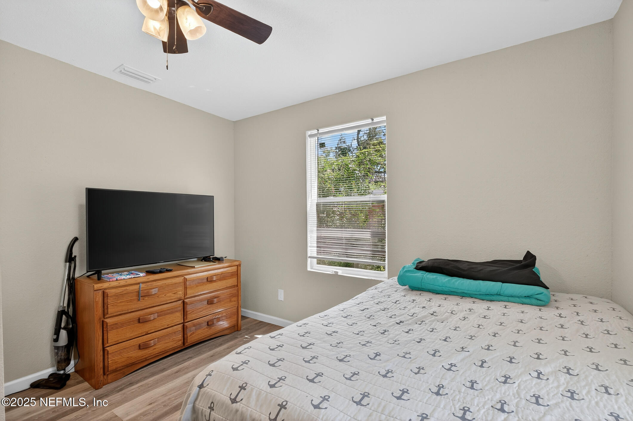 631 Moore Street Baldwin, FL 32234 - Photo 27 of 36 a bedroom with a bed and flat screen tv