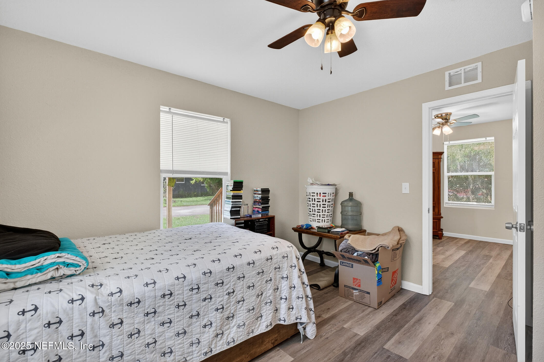 631 Moore Street Baldwin, FL 32234 - Photo 28 of 36 a bedroom with a bed and wooden floor
