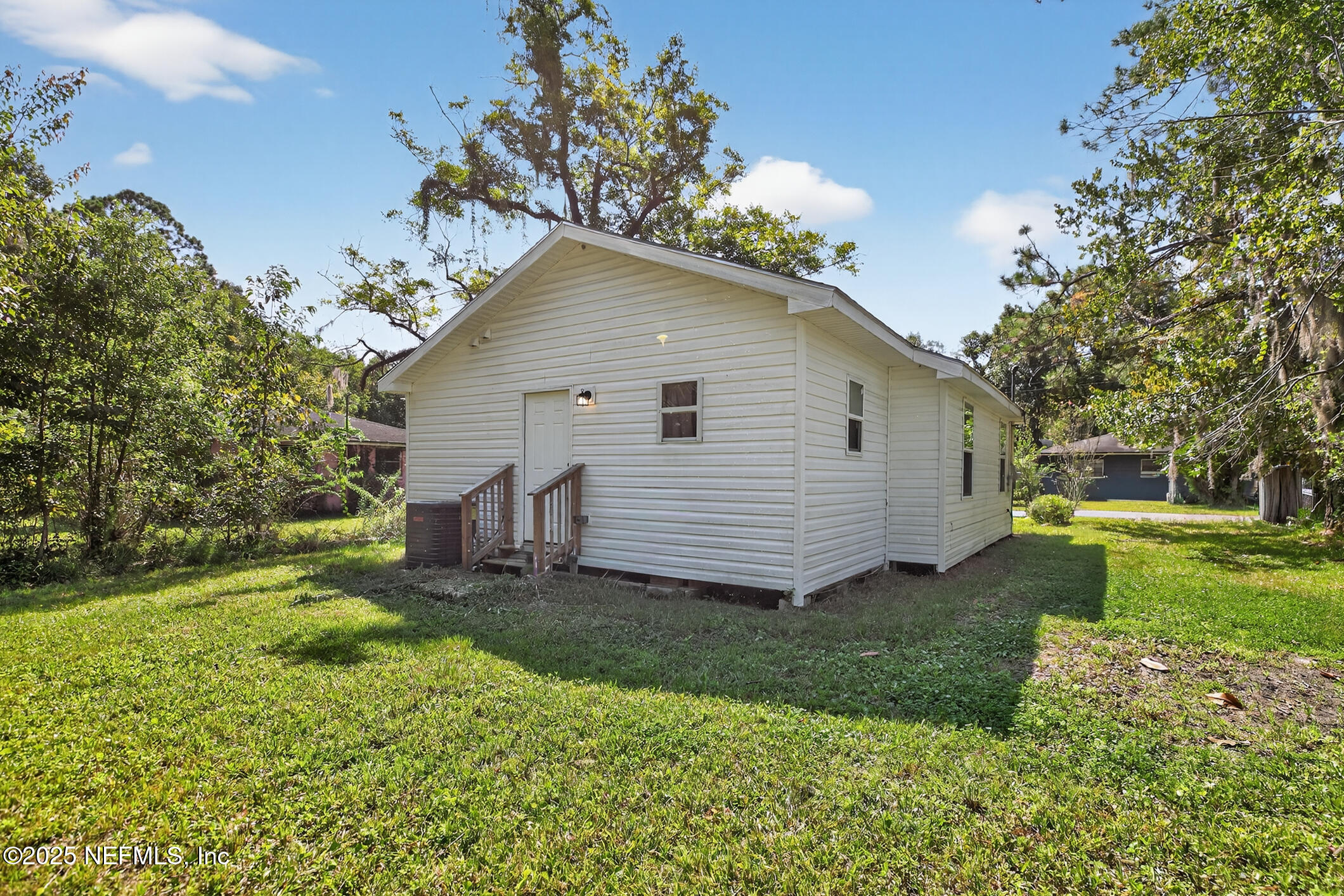 631 Moore Street Baldwin, FL 32234 - Photo 30 of 36 a view of a house with a yard
