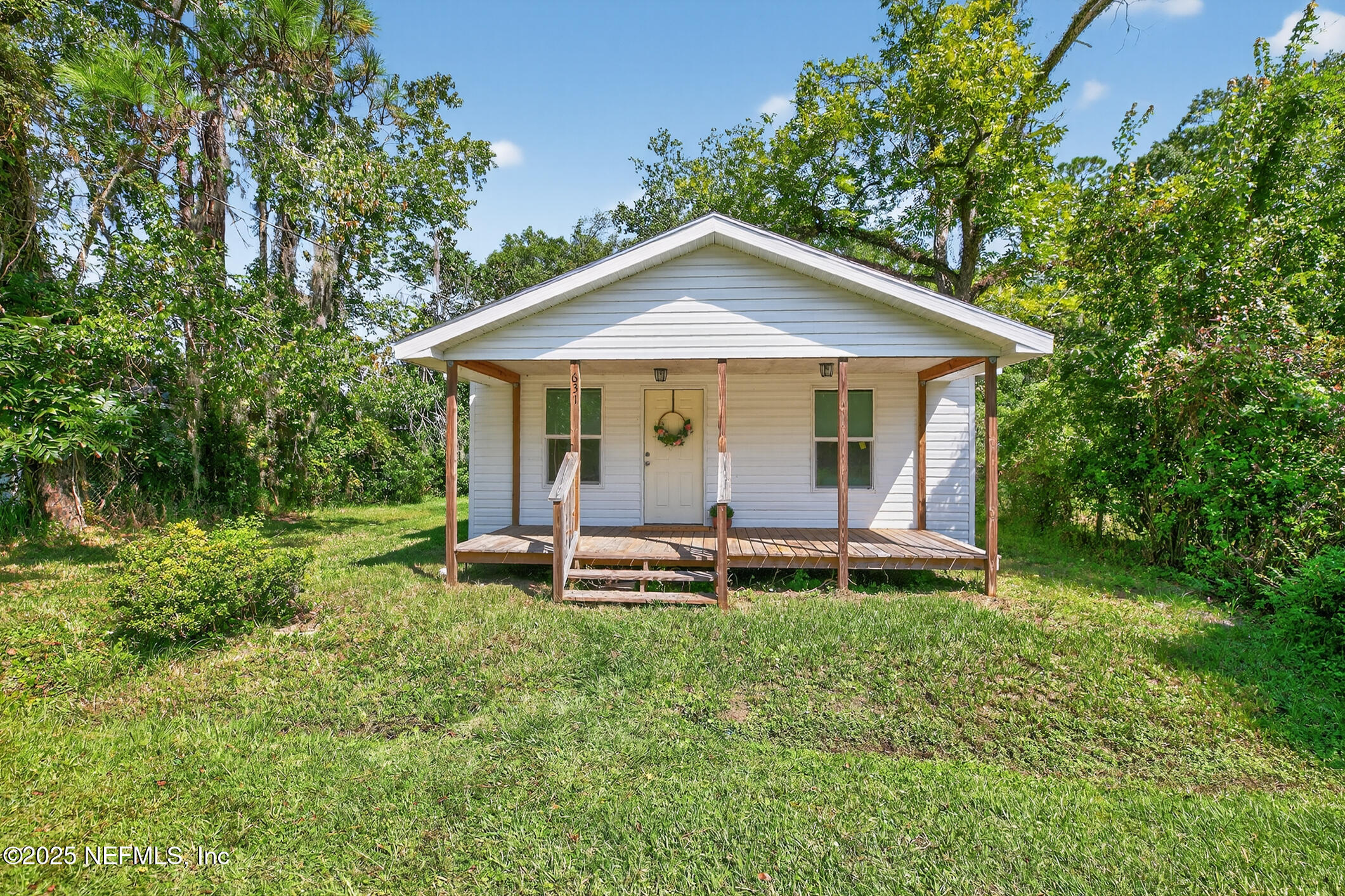 631 Moore Street Baldwin, FL 32234 - Photo 4 of 36 a view of a chair and table in backyard of the house