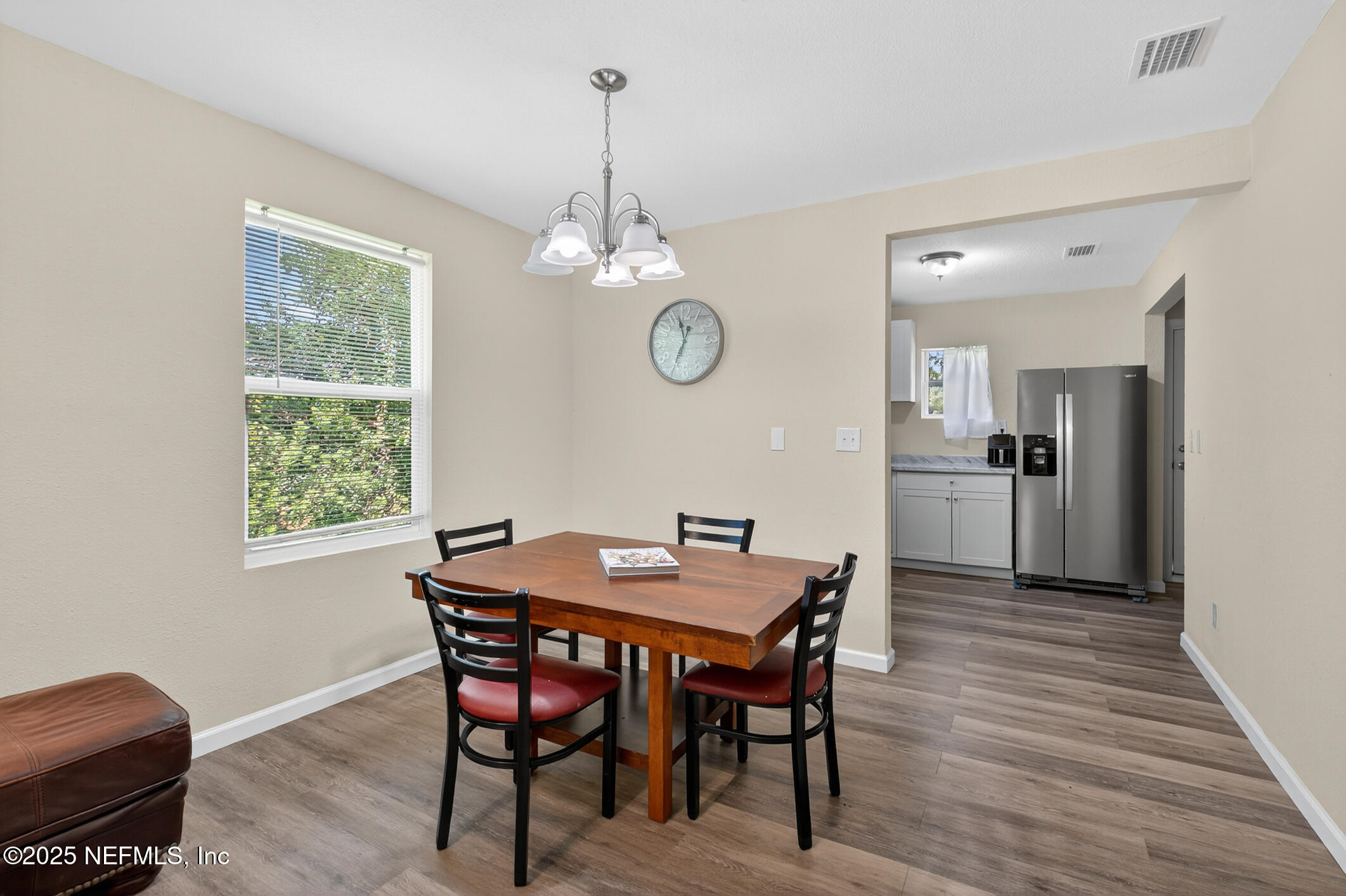 631 Moore Street Baldwin, FL 32234 - Photo 10 of 36 a view of a dining room with furniture window and wooden floor