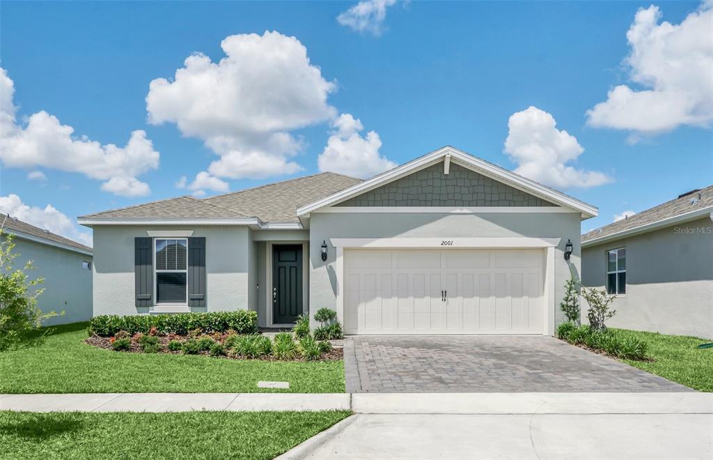 2001 Spring Shower Circle Kissimmee, FL 34744 - Photo 1 of 25 a front view of a house with garden