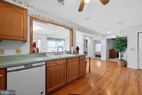 a kitchen with sink cabinets and wooden floor
