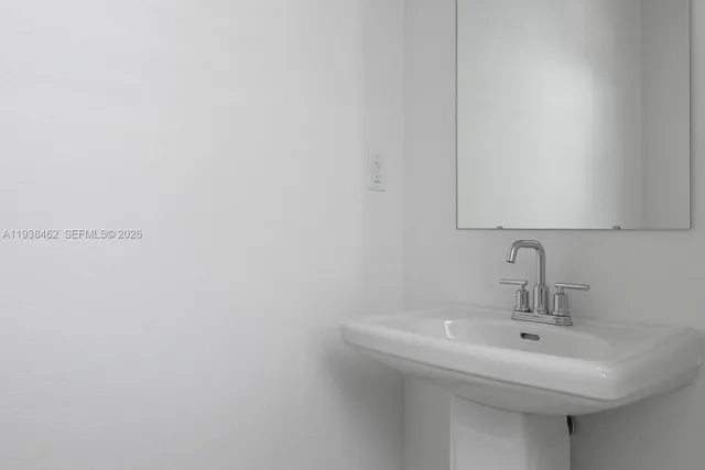 a bathroom with a sink and mirror