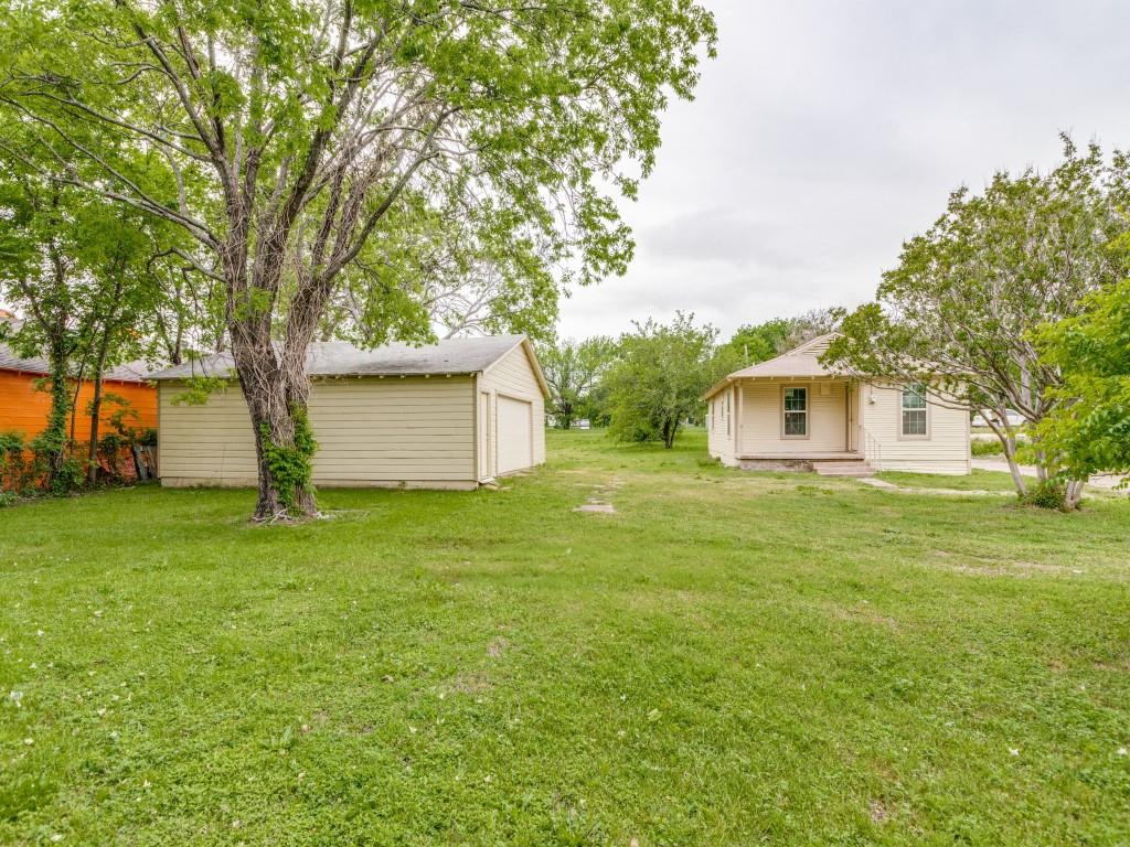 a front view of house with yard and trees