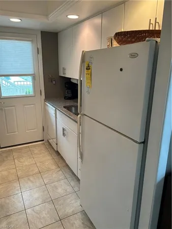 a white refrigerator freezer sitting inside of a kitchen