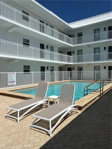 a view of a living room with furniture and a book shelf