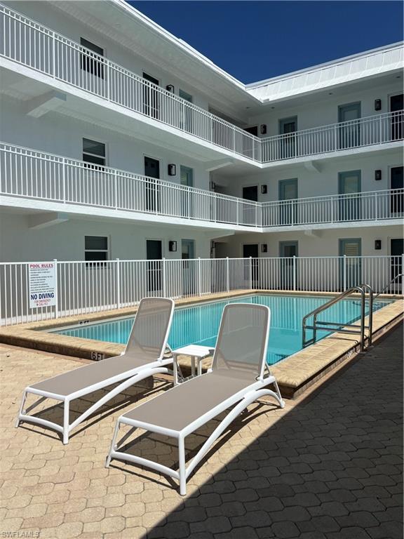1021 3rd Street South, Unit 200 Naples, FL 34102 - Photo 24 of 26 a view of a living room with furniture and a book shelf