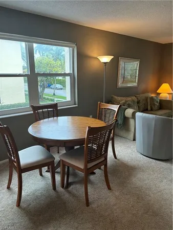 a view of a dining room with furniture and window