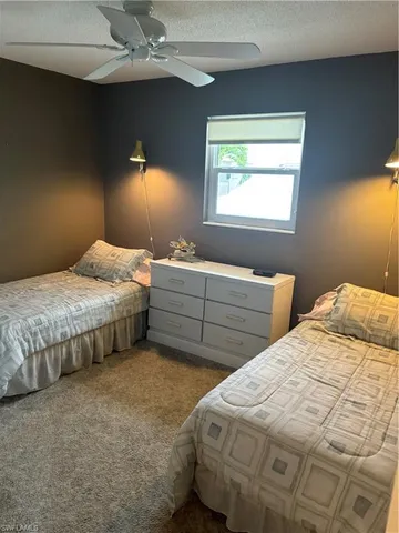 a bedroom with two beds and a window