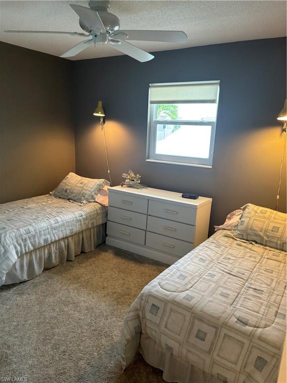1021 3rd Street South, Unit 200 Naples, FL 34102 - Photo 10 of 26 a bedroom with two beds and a window