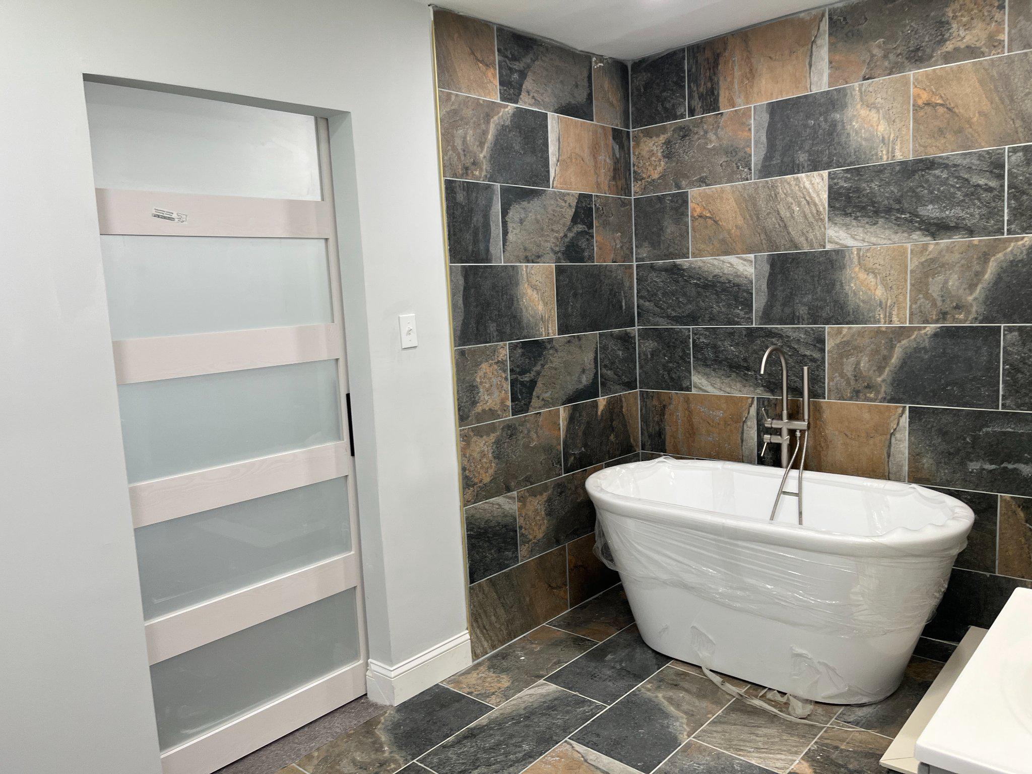 2405 Limestone Road Wilmington, DE 19808 - Photo 33 of 40 a white bath tub sitting in a bathroom
