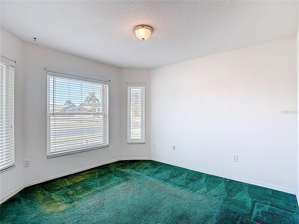4824 Woodmere Road Land O Lakes, FL 34639 - Photo 11 of 50 an empty room with windows