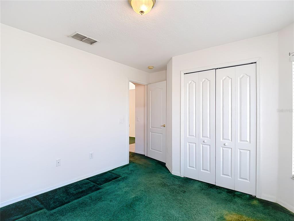 4824 Woodmere Road Land O Lakes, FL 34639 - Photo 12 of 50 a view of a storage & utility room with a window
