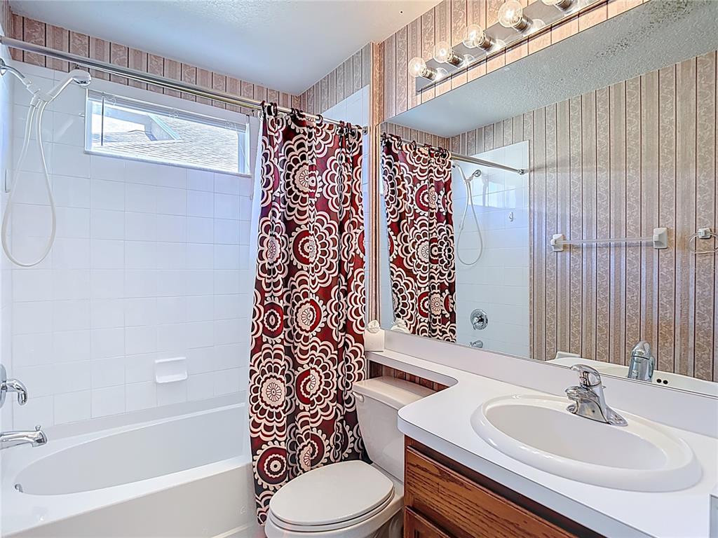 4824 Woodmere Road Land O Lakes, FL 34639 - Photo 13 of 50 a bathroom with a sink toilet and shower