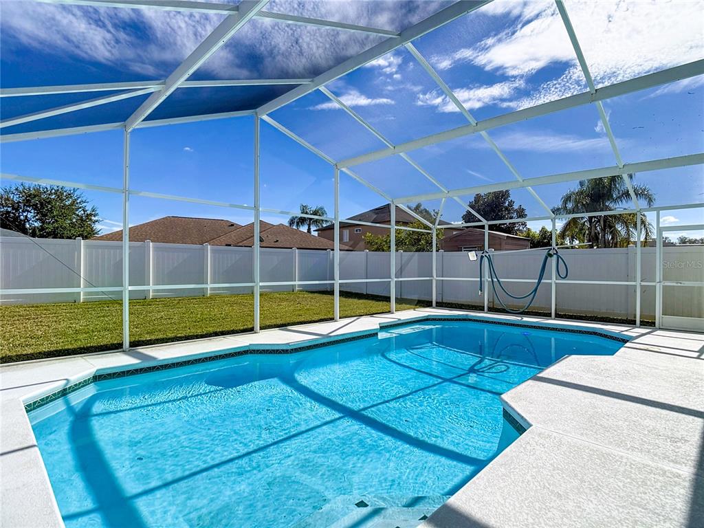 4824 Woodmere Road Land O Lakes, FL 34639 - Photo 2 of 50 a view of a backyard with swimming pool