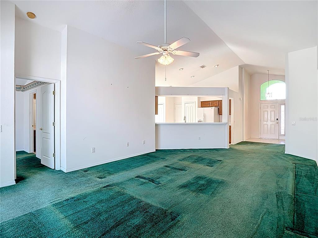4824 Woodmere Road Land O Lakes, FL 34639 - Photo 22 of 50 a view of an empty room with window and wooden floor