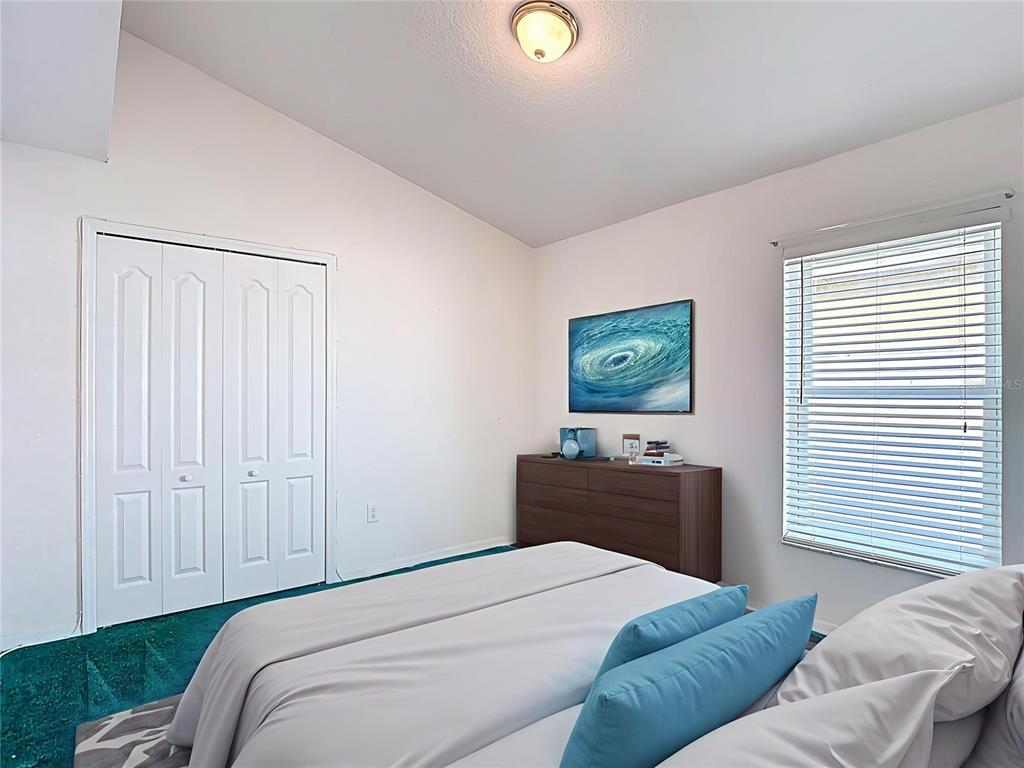 4824 Woodmere Road Land O Lakes, FL 34639 - Photo 23 of 50 a bedroom with a bed and a lamp on dresser
