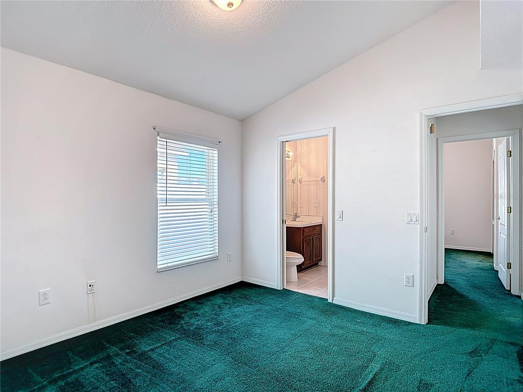 4824 Woodmere Road Land O Lakes, FL 34639 - Photo 25 of 50 an empty room with windows