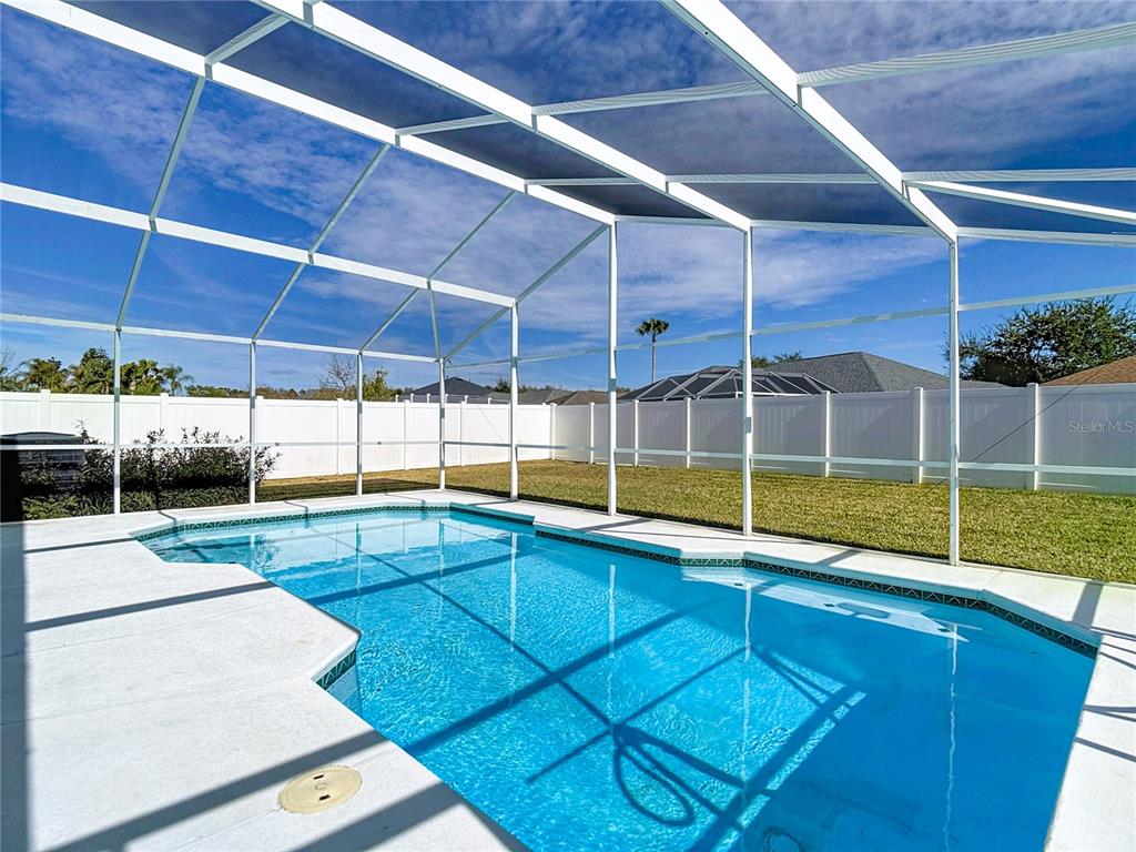 4824 Woodmere Road Land O Lakes, FL 34639 - Photo 37 of 50 a view of a backyard with a swimming pool