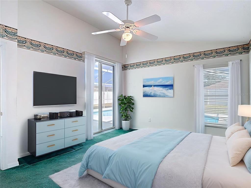 4824 Woodmere Road Land O Lakes, FL 34639 - Photo 4 of 50 a bedroom with a large bed and a flat tv screen on dresser